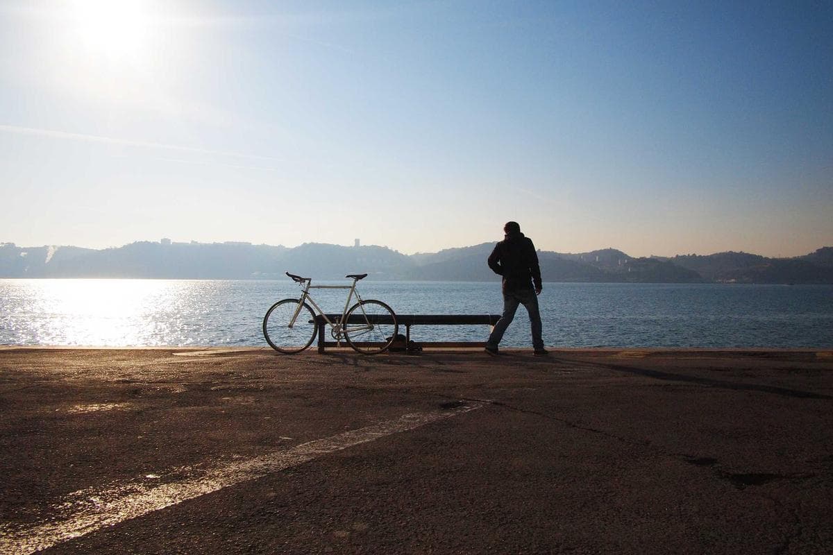 Backlit silhouette on a waterfront promenade