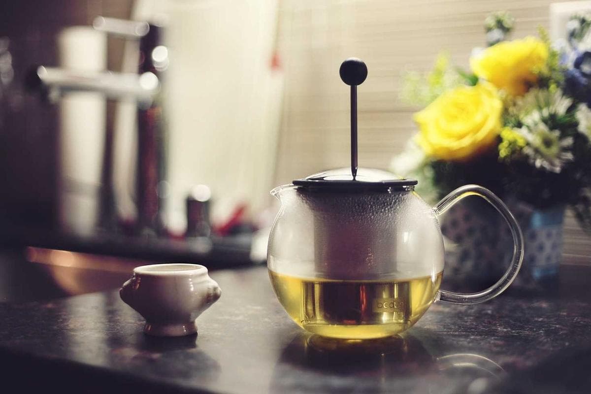 Glass teapot on a kitchen counter, soft focus