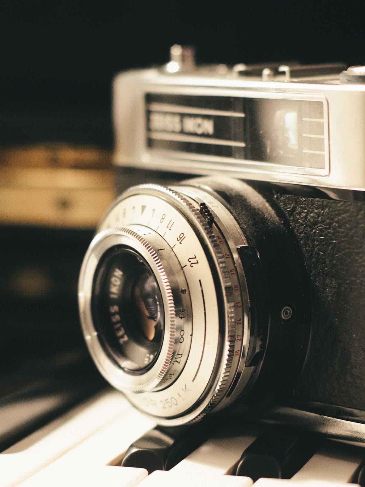 Rangefinder camera resting on piano keys
